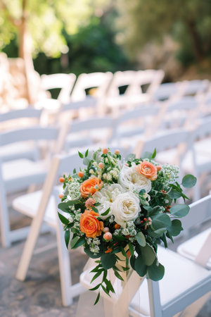 Bouquet of Flowers Resting on a White Chairの素材