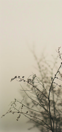 A bird gracefully sits atop a tree branch, surveying its surroundings.の素材
