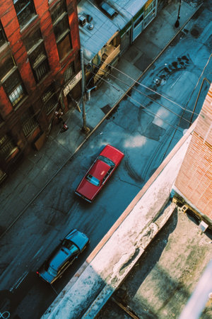 Red Car Parked on Side of Buildingの素材