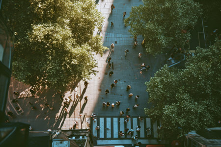 Group of People Walking Down Street Next to Trees in Urban Settingの素材