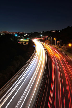 Nighttime Long Exposure Photo of a Busy Highway With Car Trailsの素材
