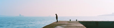 Person Standing on Pier, Looking at Oceanの素材