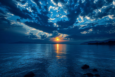 Sun Setting Over Ocean With Clouds in Sky, Tranquil Evening Sceneの素材