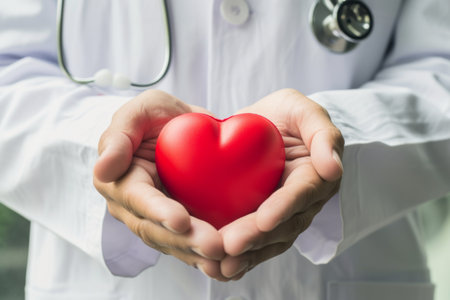 Doctor holding a red heart in hands. Health care and medical concept.の素材