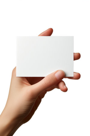 Woman's hand holding a blank business card isolated on white background.の素材