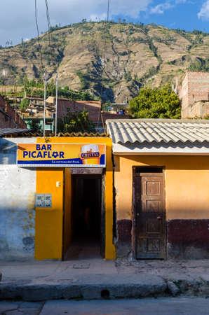 Yungay, Peru, July 17, 2014: Peruvian tavern door next to another door with beer and mount advertising in the backgroundのeditorial素材