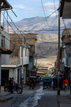 Caraz, Peru, July 19, 2010:  typical street of Peruvian town with motorcycle cars and police officersのeditorial素材