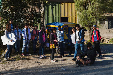 Yungay, Peru, August 4, 2014: group of humble teenagers participating in a home-made short film workshop with teacher with camera sitting on the floorのeditorial素材