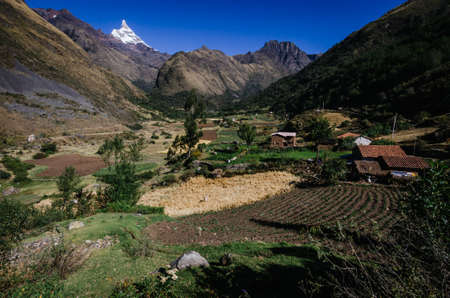 rural peasant town with agricultural land between the mountains, in the trekking of the quebrada santa cruz in peruの写真素材