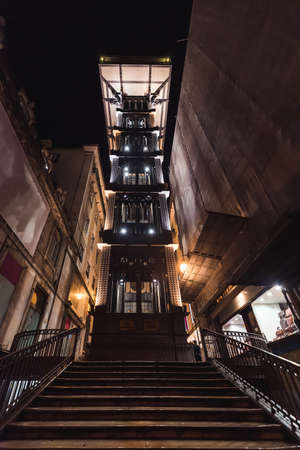 night front view of the old elevator of santa justa in lisbon, verticallyの写真素材
