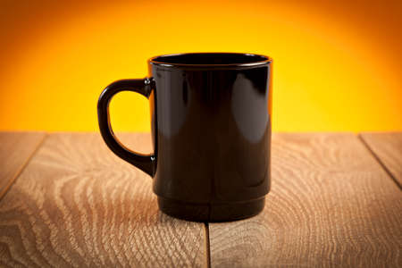 Black coffee mug on wooden tableの写真素材