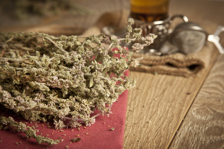 Thyme tea with flowers on a wood table backgroundの写真素材