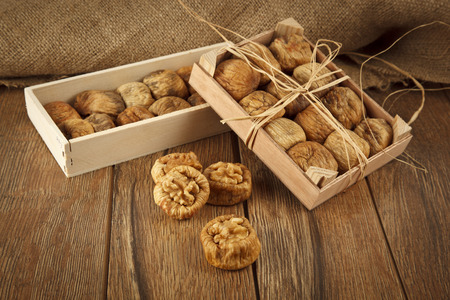 Dried figs with walnuts concept with wooden tableの写真素材
