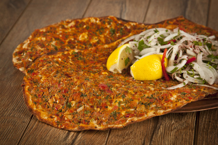 Turkish specialty pizza lahmacun pide with parsley and lemonの写真素材