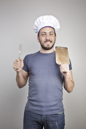 A male chef isolated over grey gradient backgroundの写真素材