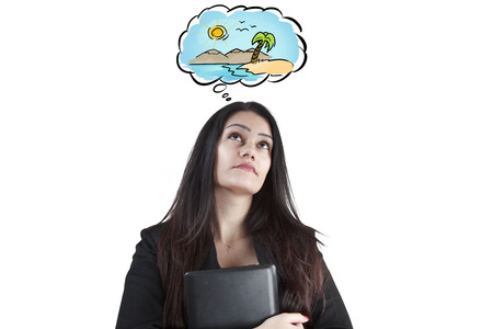 Businesswoman with the laptop thinking summer holidayの写真素材