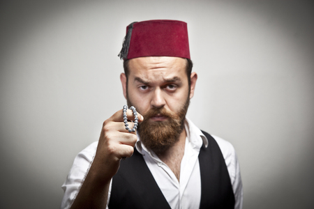 Man in traditional turkish hat and dress kabadayiの写真素材