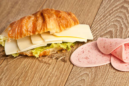 Close up of ham and cheese croissant sandwich.の写真素材