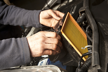 Auto mechanic working in garage. Repair service.の写真素材