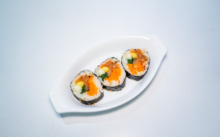 <p>Sushi rolls on a white plate isolated on a white background.</p>の写真素材