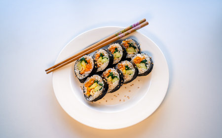 traditional korean food kimbap rice roll on white tableの写真素材