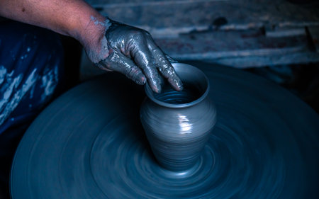 hands of a potter, creating an earthen jar on the circleの写真素材