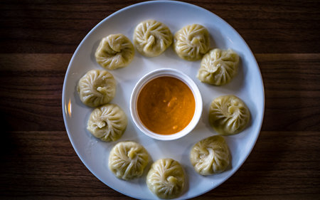 Steamed dumplings with sauce on white plate, top viewの写真素材