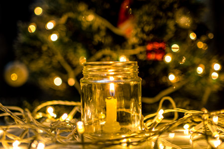 Candle light and christmas tree in the background, selective focusの写真素材