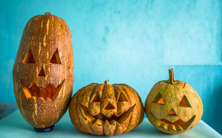 Halloween pumpkins on blue background with copy space for text.の写真素材