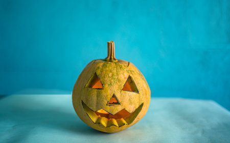 Halloween pumpkin head jack-o-lantern on blue backgroundの写真素材