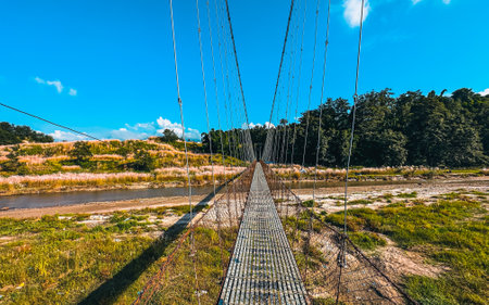 Suspension bridge over the river in the countryside, Nepalの写真素材