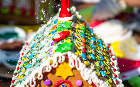 Gingerbread house decorated with colorful glaze and sprinkles.の写真素材