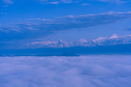 Beautiful view of clouds and mountain peaks in the blue sky backgroundの写真素材