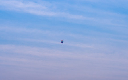 Colorful hot air balloon flying in the blue sky at sunset.の写真素材