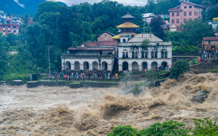 The Bagmati River flooded and affected the riverbanks and homes during heavy rainfall in Kathmandu, Nepalの写真素材