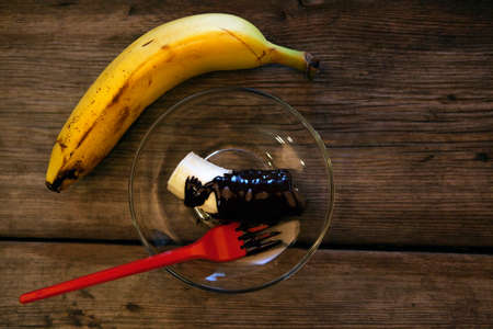 Banana hot chocolate plate wooden tableの写真素材