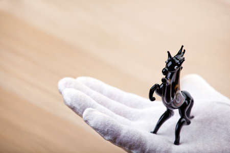 black horse figure hand white gloves tableの写真素材
