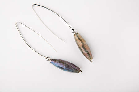 silver earrings labradorite stone white backgroundの写真素材