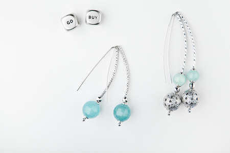 silver earrings stone set white background