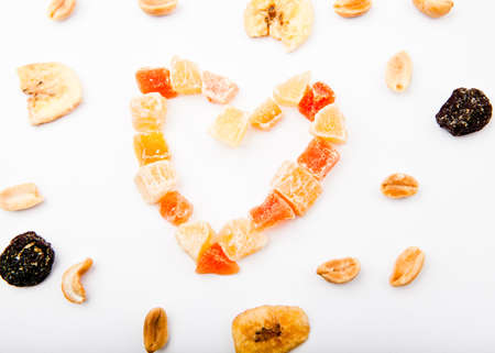 Dried fruits nuts Heart symbol white backgroundの写真素材