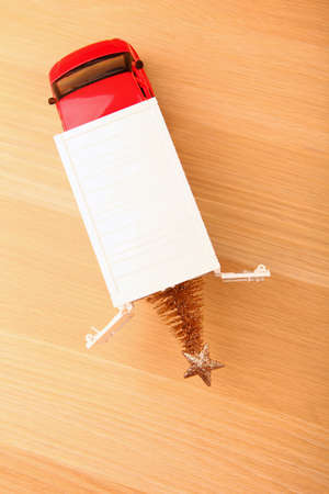 red toy car miniature fir tree wooden table