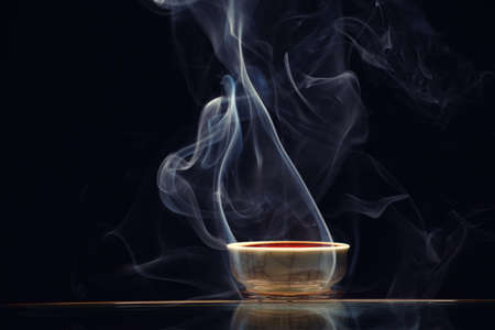 Chinese black tea cup smoke dark background nobody