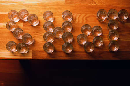 empty shot glass text wooden tableの写真素材