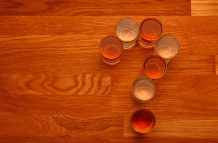 alcohol glass shot question mark wooden tableの写真素材