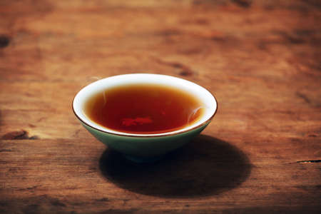 black hot tea cup wooden deskの写真素材