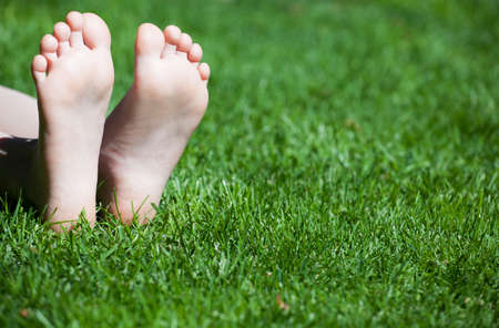 children girl foot grass backgroundの写真素材