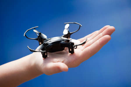 quadcopter children hand blue background