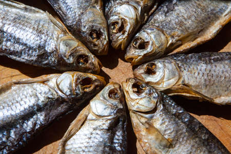 dried salt fish wooden backgroundの写真素材