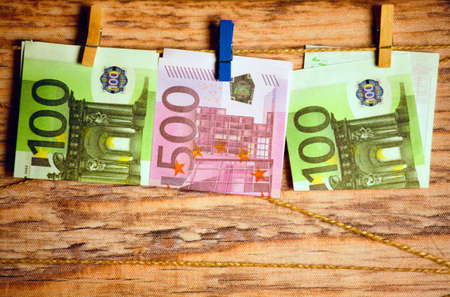 money clothespin rope plastic background