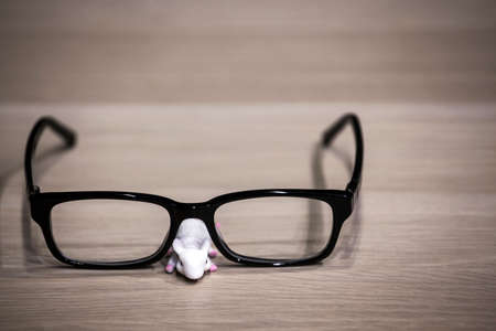 mouse glasses wooden table backgroundの写真素材